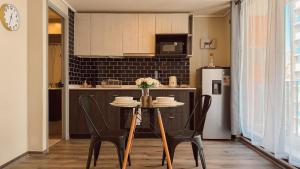 a kitchen with a table with chairs and a refrigerator at Getaway in Valparaiso in Valparaíso