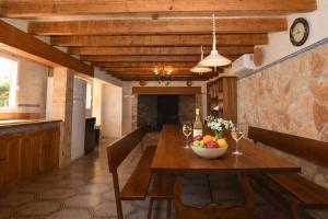 a dining room with a wooden table with a bowl of fruit at 409 Villa Can Bril ETV1523 by Mallorca Charme in Campos