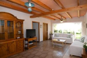 a living room with a couch and a tv at 409 Villa Can Bril ETV1523 by Mallorca Charme in Campos