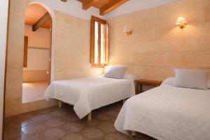 a room with two beds and a mirror at 409 Villa Can Bril ETV1523 by Mallorca Charme in Campos +25 photos