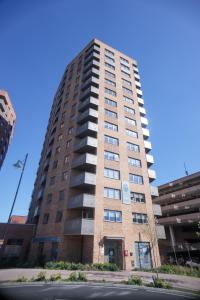 a tall brick building on the side of a street at Little Haven Thames view Free Parking Closer to Heathrow in Staines