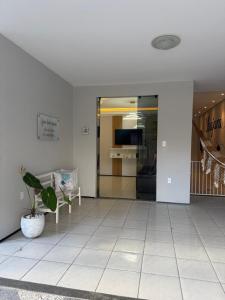 a lobby with a door and a potted plant at Serra Charm House in Ubajara