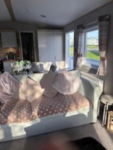 a living room with a couch with pillows on it at Honey's Retreat in Hull