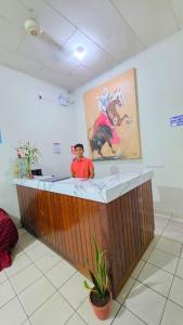a man standing in a bath tub in a room at Hospedaje RIO BLANCO in Iquitos