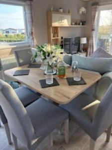 a dining room table with chairs and a couch at Honey's Retreat in Hull
