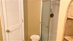 a shower with a glass door in a bathroom at Flip Flop Beach in Cape May Point