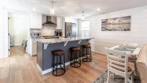 a kitchen with a counter and a table in a room at Little Cottage On Lafayette in Cape May