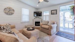 a living room with two couches and a fireplace at Little Cottage On Lafayette in Cape May