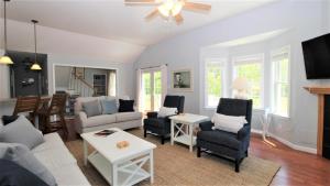a living room with a couch and chairs at Fairwinds Cottage in Cape May