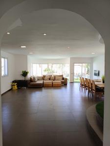 a living room with a couch and a table and chairs at Villa Dreamy Pool Garden in Eilat