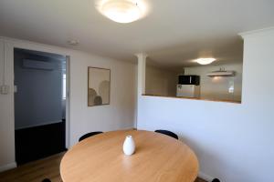 a dining room with a wooden table and chairs at Pine Country Caravan Park in Mount Gambier