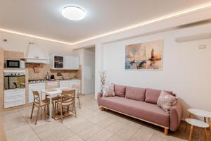 a living room with a couch and a table at Port Haven Suite Civitavecchia in Civitavecchia +29 photos