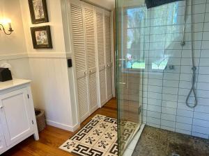 a bathroom with a shower with a glass door at Gibbston Boathouse with Outdoor Bath in Gibbston +38 photos