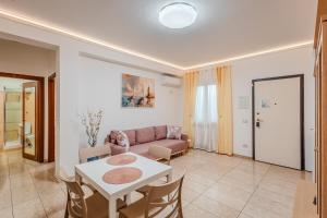 a living room with a couch and a table at Port Haven Suite Civitavecchia in Civitavecchia