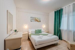 a small bedroom with two beds and a window at Port Haven Suite Civitavecchia in Civitavecchia