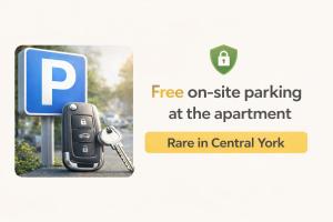 a parking sign with a car key next to a parking sign at Serenity Inn the City in York