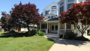 a white house with trees in front of it at Failte in West Cape May
