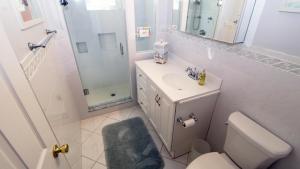 a bathroom with a toilet and a sink and a mirror at Life S A Beach in Cape May +13 photos