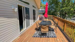 a deck with a table and chairs and an umbrella at 149 Emerald Avenue in West Cape May