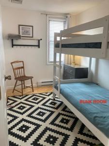a bedroom with a bunk bed and a desk and a chair at Ocean Block Wifi Beach Badges Ship Bottom in Ship Bottom