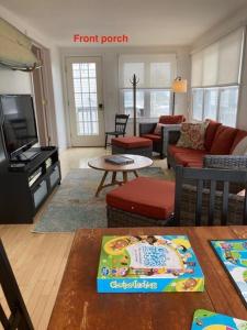 a living room with a couch and a living room with a flat screen tv at Ocean Block Wifi Beach Badges Ship Bottom in Ship Bottom
