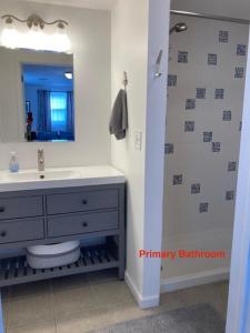 a bathroom with a sink and a mirror at Ocean Block Wifi Beach Badges Ship Bottom in Ship Bottom +17 photos
