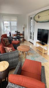 a living room with couches and a flat screen tv at Ocean Block Wifi Beach Badges Ship Bottom in Ship Bottom