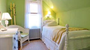 a green bedroom with a bed and a window at 637 Seagrove in Cape May Point