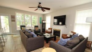 a living room with two couches and a ceiling fan at The Happy Heron in West Cape May