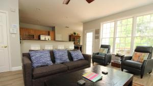 a living room with a couch and two chairs at The Happy Heron in West Cape May