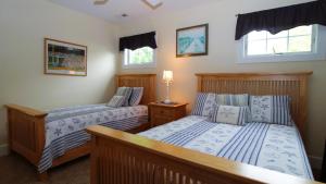 a bedroom with two beds and two windows at 320 Knox Avenue, Cape May Point in Cape May Point