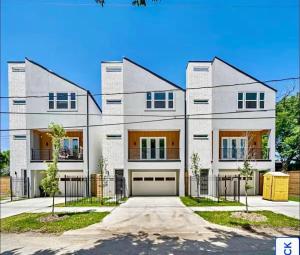 a large white house with a garage at Villa De Briley - Luxury Creator Station - Fire Pit in Houston