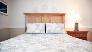 a bedroom with a bed with a wooden headboard and pillows at Broadway Beach Getaway Unit 2 in Cape May