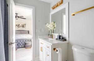 a bathroom with a sink and a mirror at Villa De Briley - Luxury Creator Station - Fire Pit in Houston +27 photos