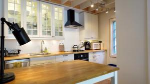 a kitchen with white cabinets and a wooden counter top at 639 Seagrove in Cape May Point +7 photos