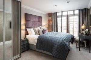 a bedroom with a bed and a desk and a window at Serenity Inn the City in York