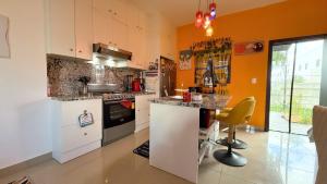 a kitchen with orange walls and a counter top at Cozy 1 bedroom in Punta Cana