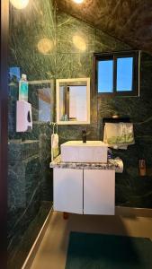 a bathroom with a sink and a mirror at Cozy 1 bedroom in Punta Cana +3 photos