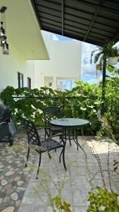 a patio with a table and chairs and plants at Cozy 1 bedroom in Punta Cana