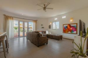 a living room with a couch and a ceiling fan at Baja Beach Pad at Cerritos in El Pescadero