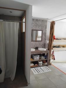 a bathroom with a shower curtain and a sink at La Pommeraie in Casteil