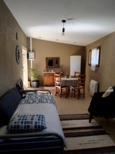 a bedroom with a bed and a dining room with a table at La Pommeraie in Casteil
