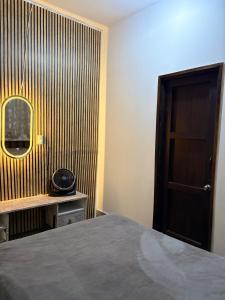 a bedroom with a bed and a wooden wall at Casa Paloma Querida in Taxco de Alarcón