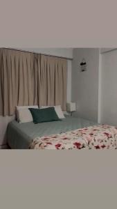 a hotel room with a bed and a window at Flat in Caldas Novas in Caldas Novas +13 photos