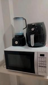 a blender sitting on top of a microwave at Flat in Caldas Novas in Caldas Novas
