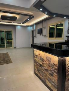 a large room with a kitchen with a counter top at قريه نڤيرت in Fayed