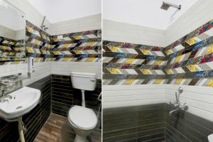 a bathroom with a toilet and a sink at Super OYO Hotel O Indira Nagar in Lucknow +42 photos