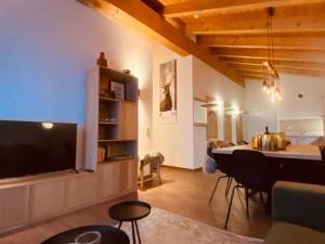 a living room with a large television and a table at Emma Top 4 in Dienten am Hochkönig