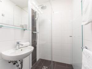 a white bathroom with a sink and a shower at Emma Top 2 in Dienten am Hochkönig +46 photos