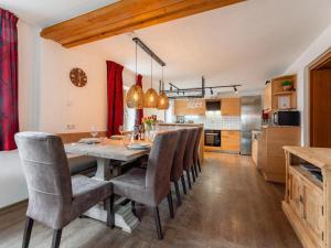 a kitchen and dining room with a table and chairs at Kitzbüheler Alpen XL in Bramberg am Wildkogel